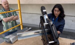 Maihan Ali of George Mason University, a CFSEI student competition award winner, uses the TrueShear shearing press from Grabber to cut a sample cold-formed steel (CFS) stud during Tool Time at the 2026 CFSEI Expo in Long Beach, California.