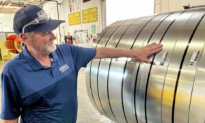Brian Thornton reviews the tagged slit coils at CEMCO's City of Industry, California, facility. The tags record information including the original coil lot, coating type, weight and length, helping maintain material traceability throughout the manufacturing process.
