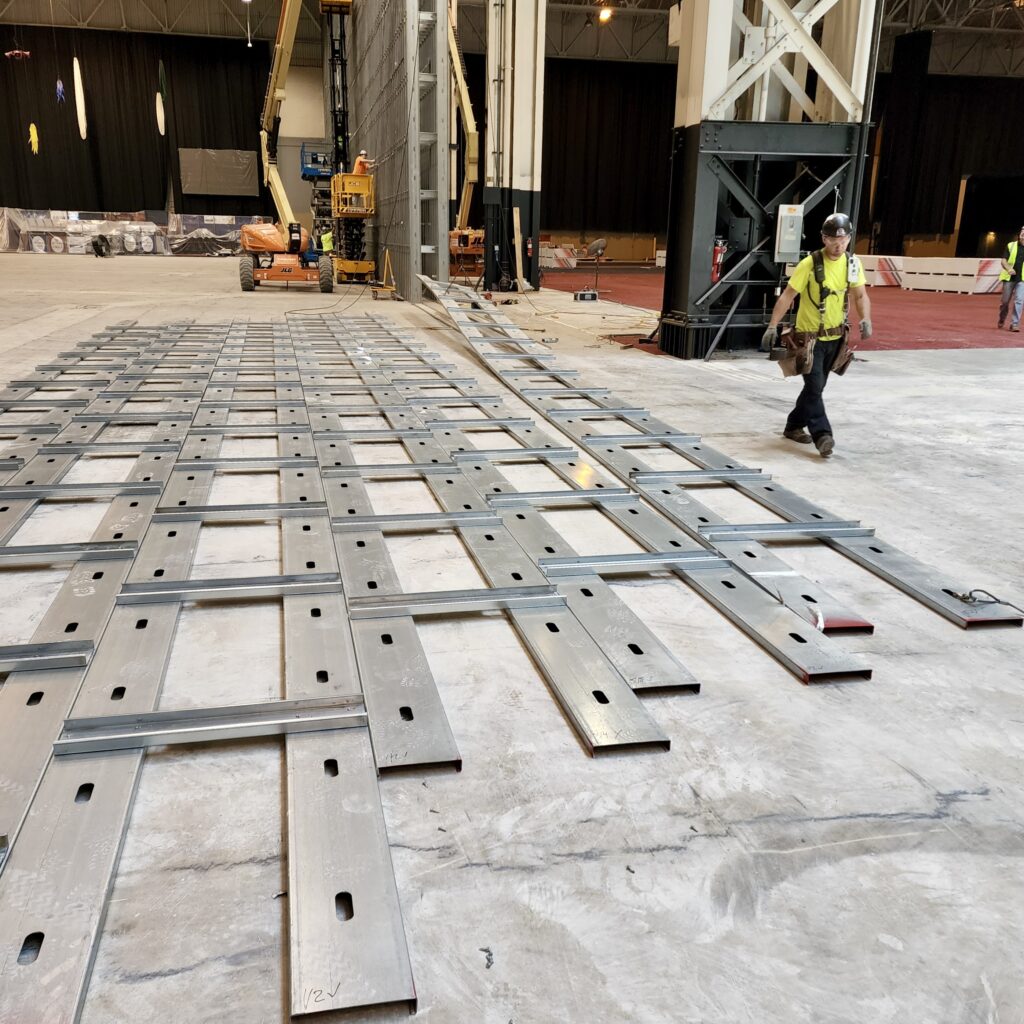 Individual cold-formed steel (CFS) stud trusses waiting to be hoisted into place at I-X Center.