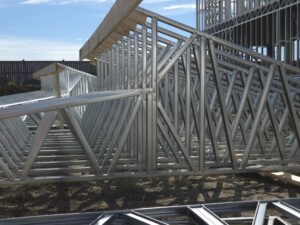 Individual roof trusses, panelized off site by Dominion Metal Frames, were assembled into a single roof system on site and lifted into place by crane.