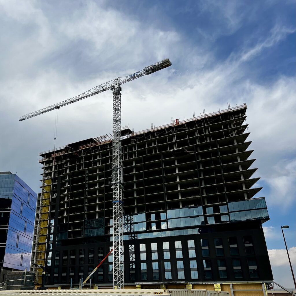 The Belleview North Tower crane lifts panels to installers. “We average 75% schedule savings on the building envelope,” Vap says. Photo courtesy of Mark L. Johnson.
