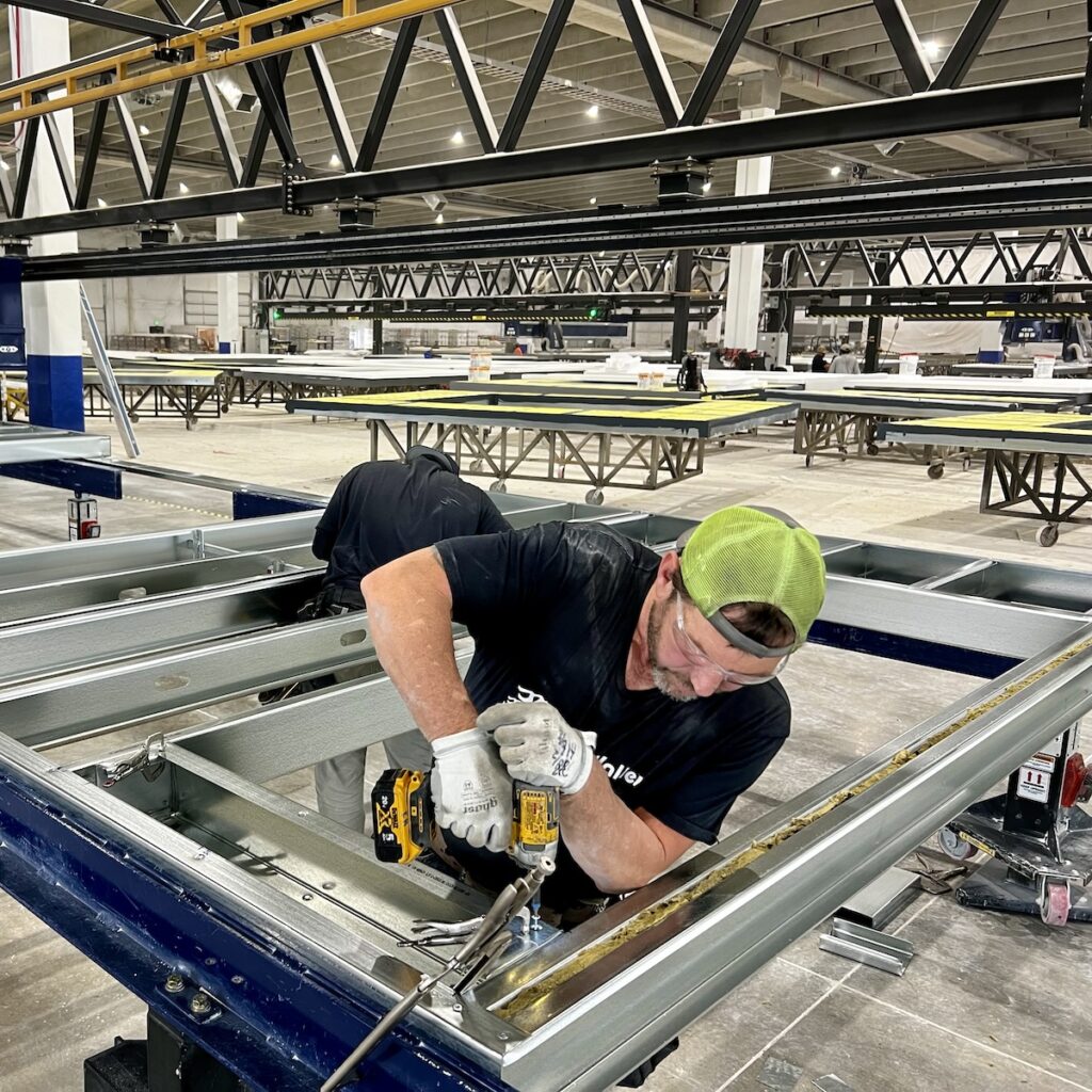 South Valley Prefab's Wayne Munro assembles cold-formed steel (CFS) panels with studs rolled in-house. Photo courtesy of Mark L. Johnson.