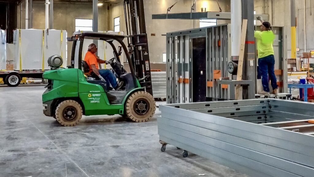 2024 SFIA Award winner: A ceiling assembly is laid in place atop the cold-formed steel (CFS) framed walls of a bathroom pod.