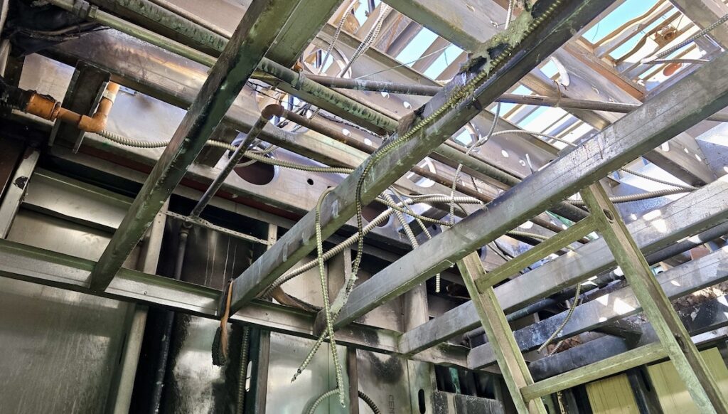 The wood is clearly missing — burned away, though the cold-formed steel (CFS) remains intact.