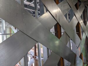 McClure designed overlapping cold-formed steel (CFS) shear walls reduced uplift reactions while accommodating existing podium embeds.