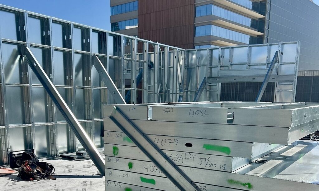 Engineers designed designated floor areas to support stacked wall panels. Crews shipped panels <yoastmark class=