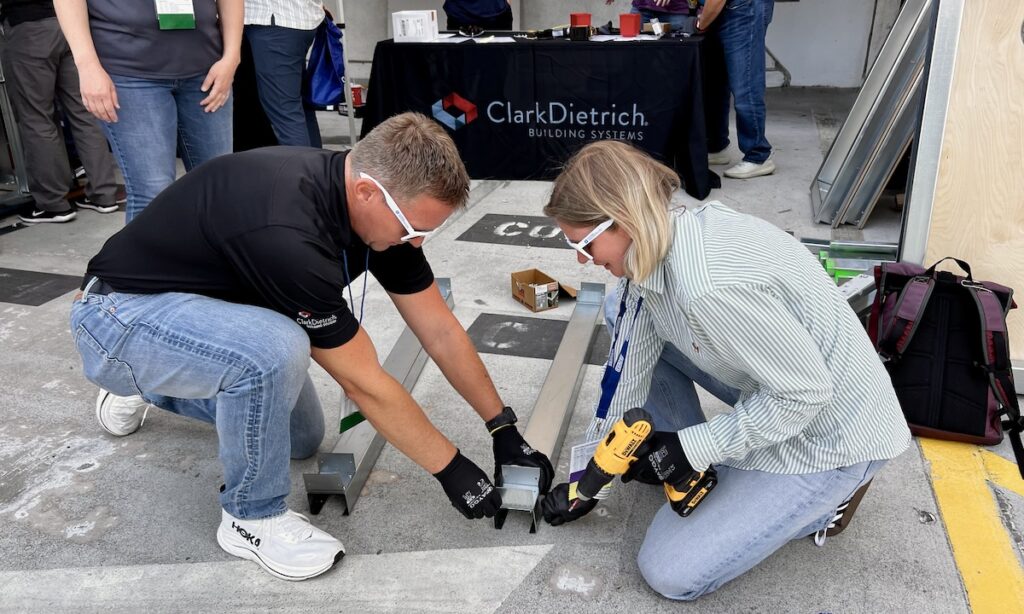 Chuck Webb of SFIA member and CFSEI Expo Diamond Sponsor ClarkDietrich helps Allyssa Pease, P.E., of SFIA member raSmith sharpen her fastening skills during "Tool Time" at the 2026 CFSEI Expo in Long Beach, California.
