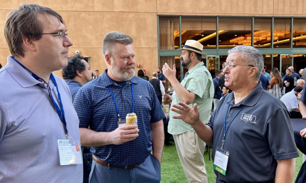 Brian Norby of American Way Engineering and Chris Raebel of the American Institute of Steel Construction join Tom Sputo of the Steel Deck Institute during CFSEI Expo’s Monday evening welcome reception.