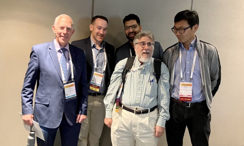 Following a NASCC 2026 session in Atlanta, Don Allen, executive director of the Steel Framing Industry Association (SFIA); Andy Newland, P.E., principal at ADTEK Engineers; Mohammad Adil Dar, assistant professor of structural engineering at BITS Pilani; Perry S. Green, Ph.D., P.E., F.SEI, F.ASCE; and Zhanjie Li, professor at SUNY Polytechnic Institute, gather for a photo.