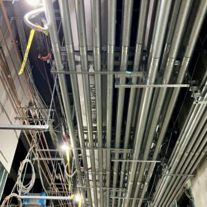 Miles of conduit run below chilled water supply pipes and other mechanical and electrical systems.