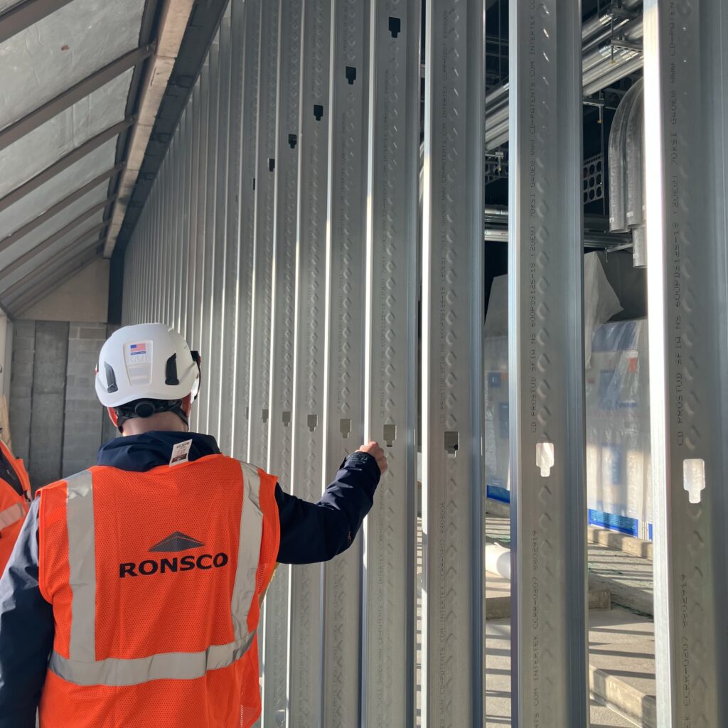 Lee Zaretzky, president of SFIA member Ronsco, Inc., inspects cold-formed steel (CFS) wall framing at a data center under construction in New Jersey.