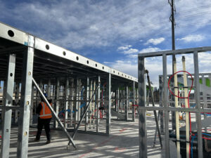 Prefabricated load-bearing cold-formed steel (CFS) wall panels incorporated strap bracing and coordinated MEP systems before arriving at the jobsite.