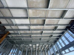 The tested two-hour fire-rated floor assembly integrated load-bearing cold-formed steel (CFS) floor joists without requiring a concrete topping slab.