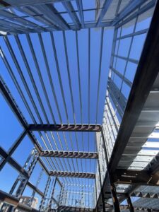 Load-bearing cold-formed steel (CFS) framing integrated with structural steel on the lower floors to create a coordinated structural system.
