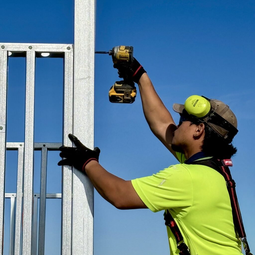 A worker assembles cold-formed steel framing. FRAMECAD’s new Steelform Core targets builders and fabricators entering or expanding off-site steel framing production.
