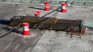 The tube member and offset embed plate provide support for concentrated cold-formed steel (CFS) shear wall reactions before placement of the topping slab.