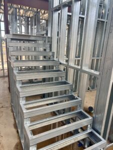 Cold-formed steel (CFS) framing provides the precision and dimensional consistency needed to construct customized stair assemblies.